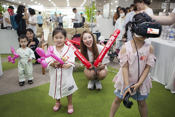 SK텔레콤이 16일 인천시 중구 인하대병원 로비에 마련한 '찾아가는 야구장'에서 어린이 환자들이 가상현실 기기를 통해 야구 게임을 즐기고 있다.