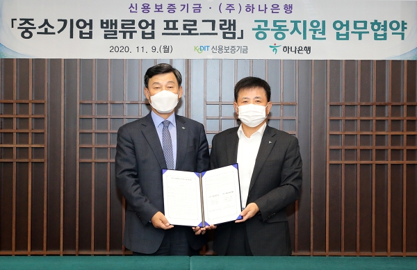 박승오 하나은행 여신그룹장(오른쪽)과 최창석 신용보증기금 상무가 협약을 체결하고 기념촬영을 하고 있다.