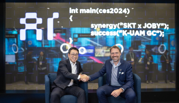 SKT 유영상 사장(왼쪽)과 Joby Aviation 조벤 비버트 CEO가 라스베이거스에서 열리는 CES 2024에 마련된 ‘SK ICT 패밀리 데모룸’에서 기념 촬영을 하고 있는